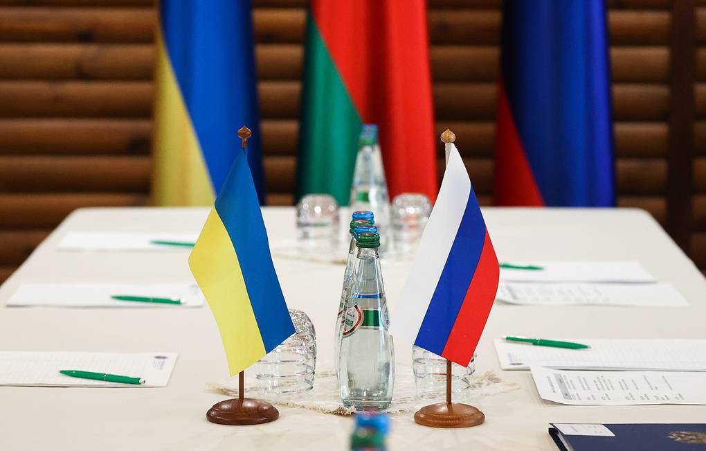 Quốc kỳ hai nước Ukraine (trái) và Nga tại bàn đàm phán ở Belovezhskaya Pushcha thuộc vùng Brest, Belarus. Ảnh: Tass